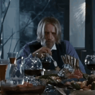 Man With Beard Sitting At Table With Wine Glasses GIF
