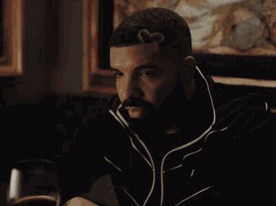 Man With Beard Sitting At Table With Wine GIF