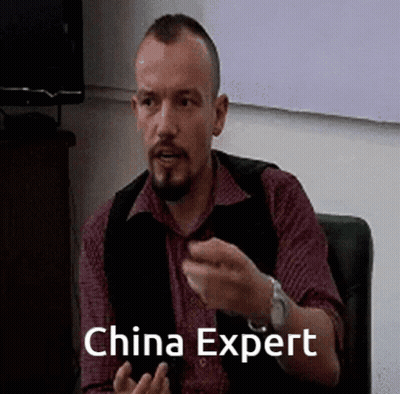 Man With Beard Sitting In Chair Saying China Expert GIF