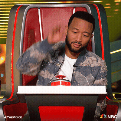 Man With Beard Sitting In Chair With NBC Logo GIF
