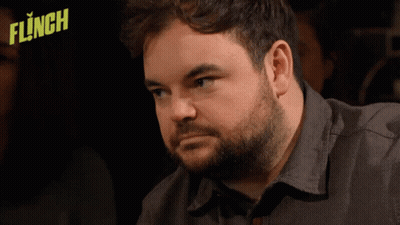 Man With Beard Sitting In Front Of Flinched Logo GIF