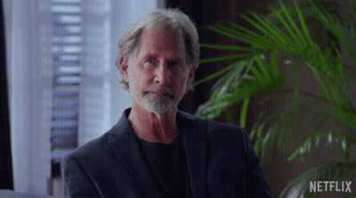 Man With Beard Sitting In Front Of Netflix Sign GIF