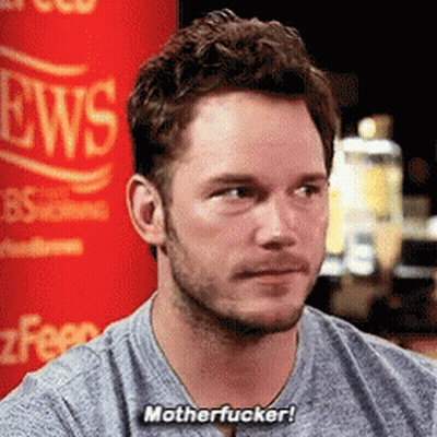 Man With Beard Sitting In Front Of Red News Sign GIF