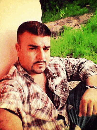 Man With Beard Sitting In Grass GIF