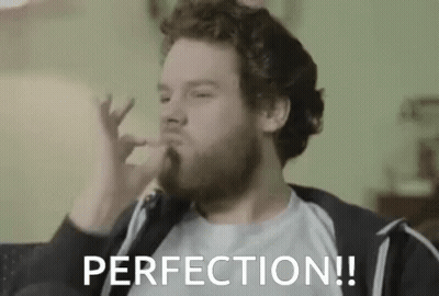 Man With Beard Sitting On Couch Hand In Mouth Perfection GIF