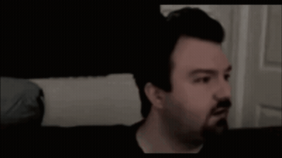 Man With Beard Sitting On Couch Saying Hellooo GIF