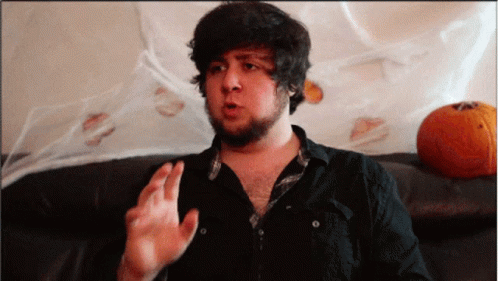 Man With Beard Sitting On Couch Talking GIF