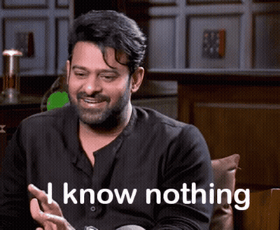 Man With Beard Sitting Smiling Saying I Know Nothing GIF