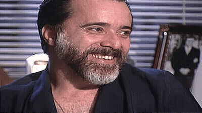 Man With Beard Smiling At Window GIF