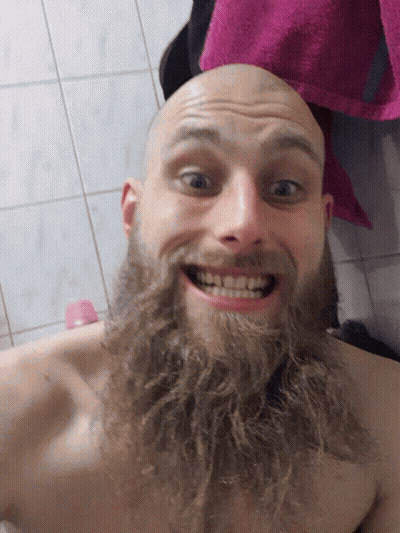 Man With Beard Smiling In Bathroom With Pink Towel GIF