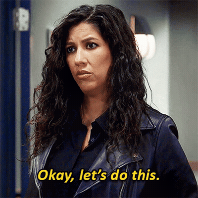 Man With Beard Smiling In Black Shirt At Door GIF