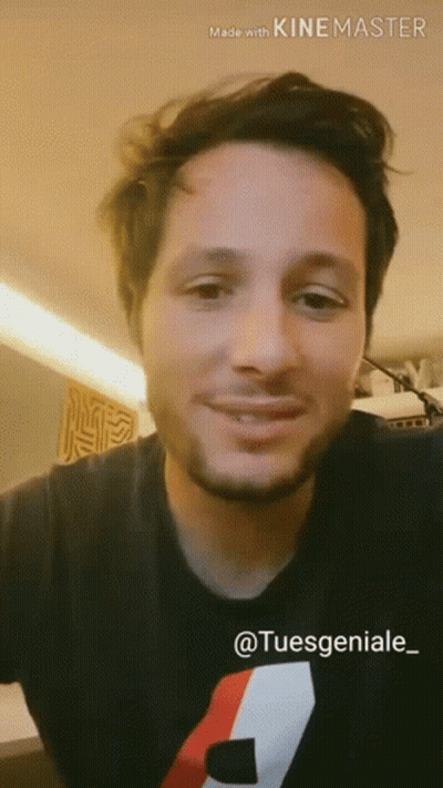 Man With Beard Smiling In Black Shirt With Red And White Stripe GIF