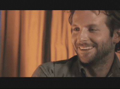 Man With Beard Smiling In Dark Room GIF