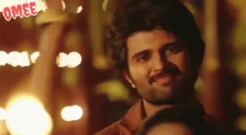 Man With Beard Smiling In Front Of Crowd GIF