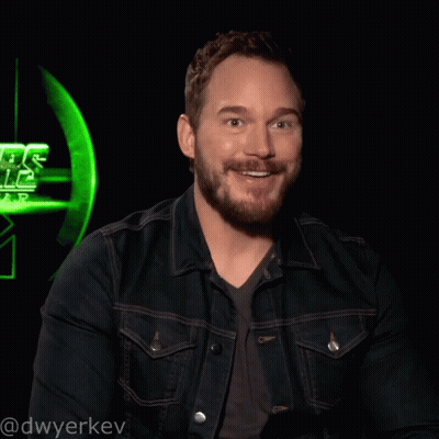 Man With Beard Smiling In Front Of Green Star Wars Logo GIF