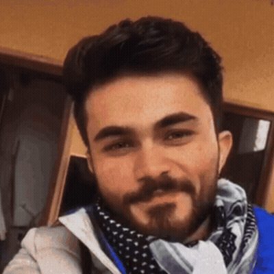 Man With Beard Smiling In Scarf And Jacket GIF