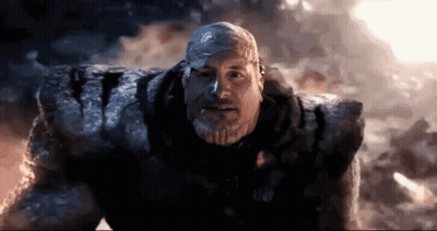 Man With Beard Standing Before Giant Rock GIF