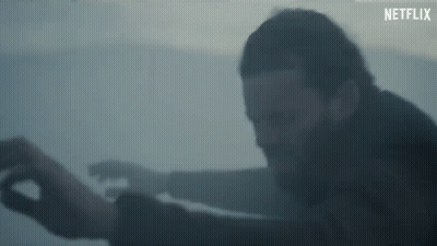 Man With Beard Standing In Foggy Room Arms Outstretched GIF