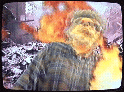Man With Beard Standing In Front Of Fire On TV GIF