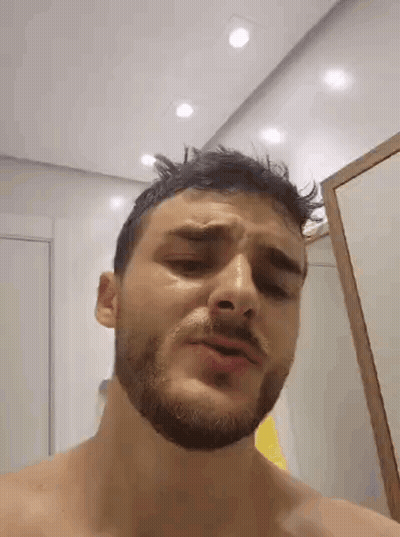 Man With Beard Standing In Front Of Mirror GIF