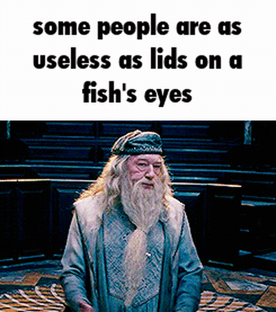Man With Beard Standing In Front Of Sign Some People Are Useless GIF