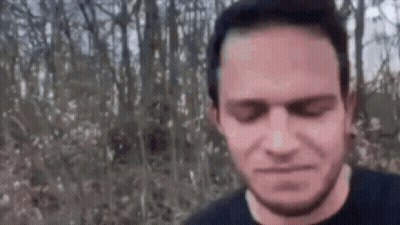 Man With Beard Standing In Woods GIF