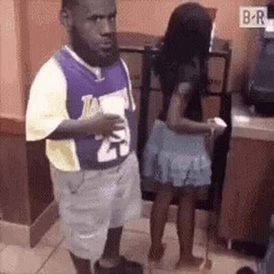 Man With Beard Standing Next To Woman In Skirt GIF