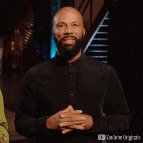 Man With Beard Standing With Hands Folded In Front Of YouTube Originals Logo GIF