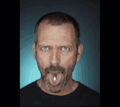 Man With Beard Sticking Out Tongue Holding Pill GIF