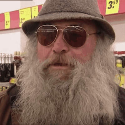 Man With Beard Sunglasses Hat In Front Of Sign Saying 3.59 GIF