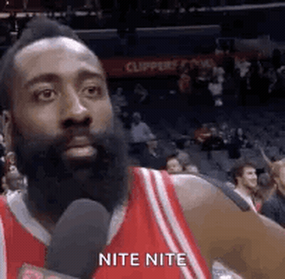 Man With Beard Talking Into Microphone In Stadium GIF