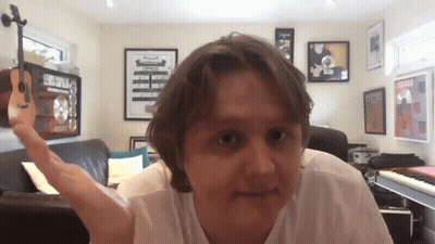 Man With Beard Talking Into Microphone With MetLife Sign GIF