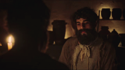 Man With Beard Talking To Another Man In Dark GIF