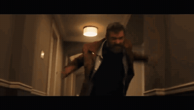 Man With Beard Walking Down Hallway GIF