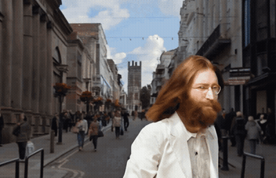 Man With Beard Walking Down Street GIF