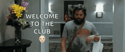Man With Beard Walking Through Hallway GIF