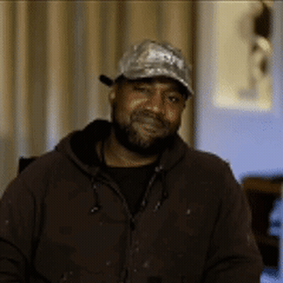 Man With Beard Wearing Baseball Cap And Brown Jacket GIF