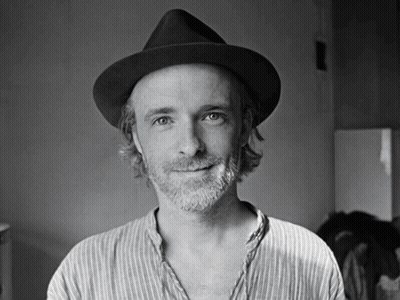 Man With Beard Wearing Black Hat And Striped Shirt GIF