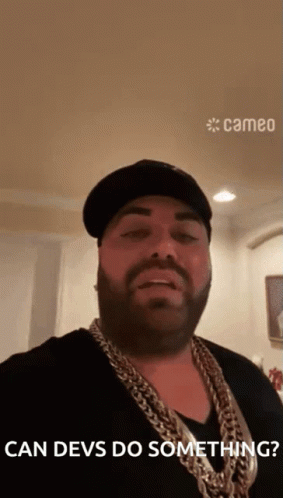 Man With Beard Wearing Hat And Chains Says Can Devs Do Something GIF