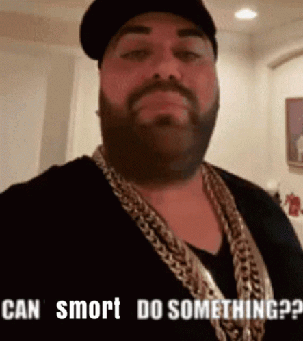 Man With Beard Wearing Hat And Gold Chain Says Can Smrt Do Something GIF