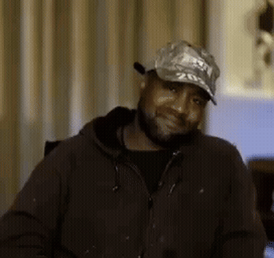 Man With Beard Wearing Hat And Jacket Smiling GIF