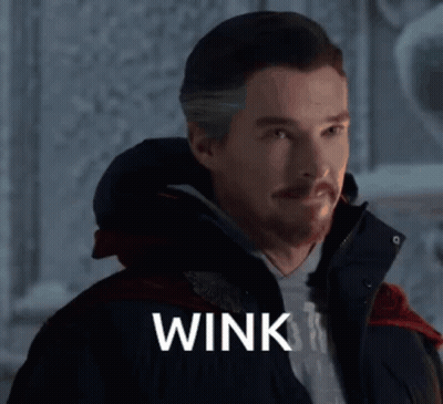 Man With Beard Wearing Jacket Saying Wink GIF