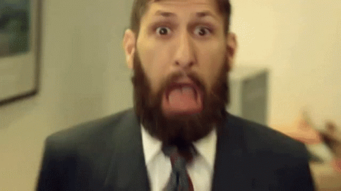 Man With Beard Wearing Suit And Tie Making Funny Face GIF