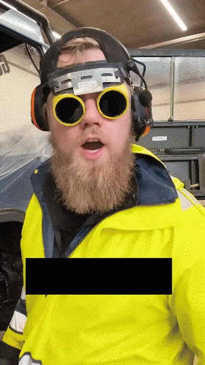 Man With Beard Wearing Welding Goggles And Ear Protectors GIF