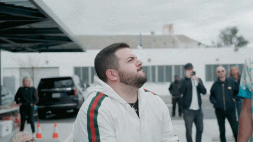 Man With Beard Wearing White Jacket Green Red Stripe GIF