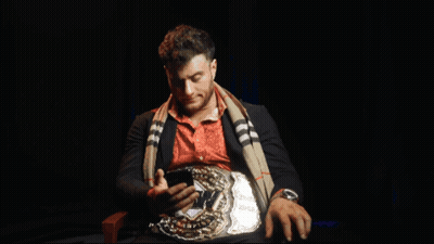 Man With Belt Holding Phone GIF