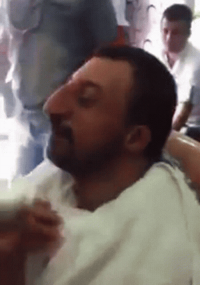 Man With Big Nose Sitting Eyes Closed GIF