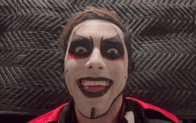 Man With Black And Red Makeup Looking At Camera GIF