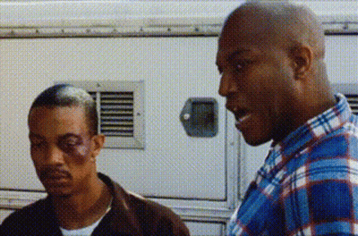 Man With Black Eye Beside Man In Plaid Shirt GIF