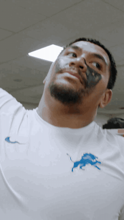 Man With Black Paint On Face In White Shirt With Blue Lion GIF